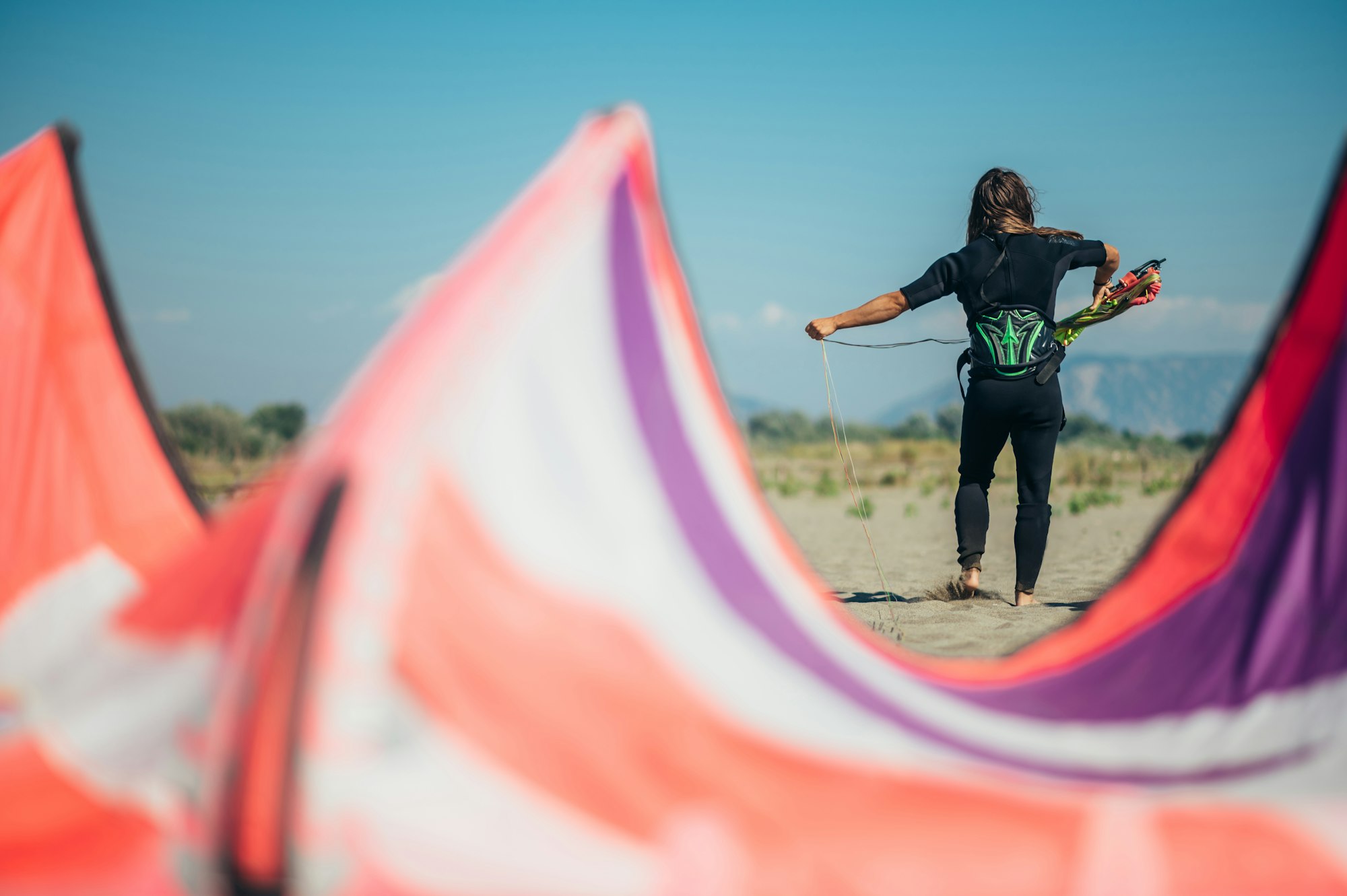Woman using flying lines and a control bar for kitesurfing